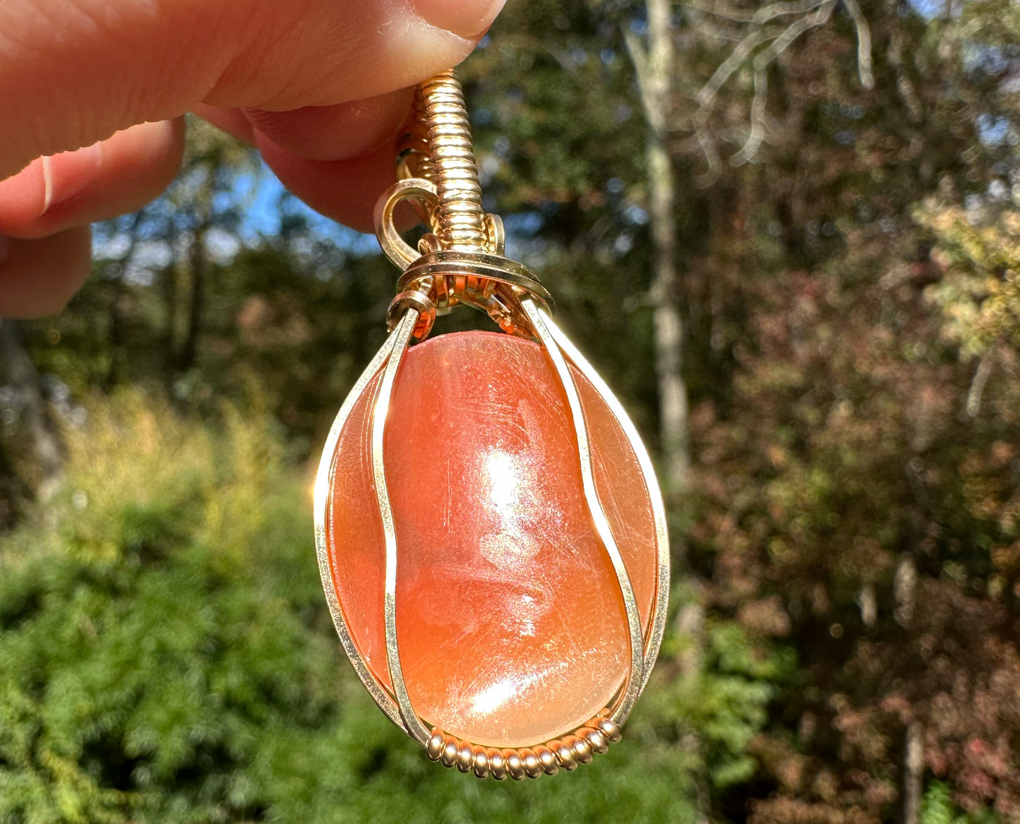 Wire wrapped 14k goldfilled wire pendant of a handcarved shell vintage cameo of a woman with a pearl necklace and flowers