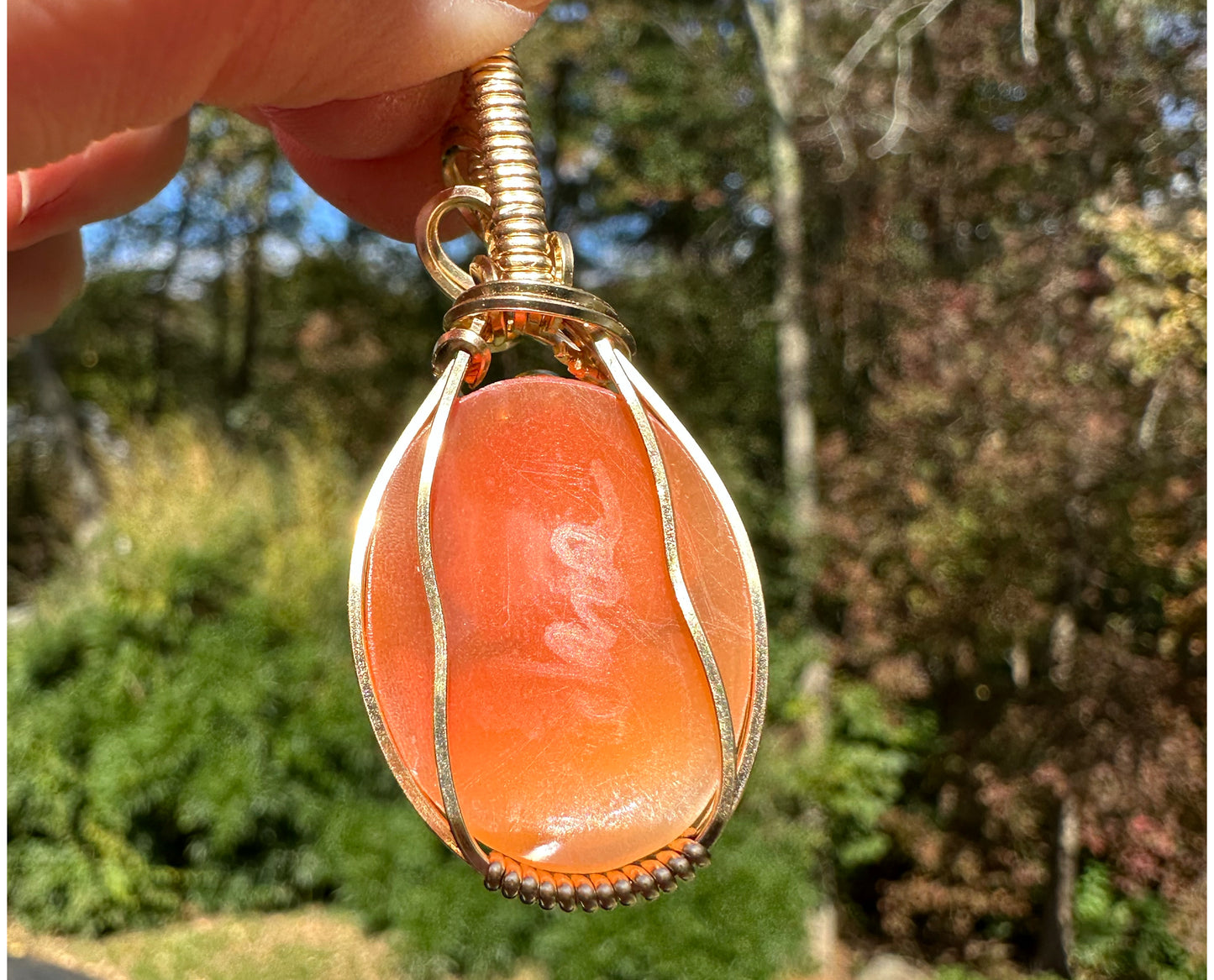 Wire wrapped 14k goldfilled wire pendant of a handcarved shell vintage cameo of a woman with a pearl necklace and flowers