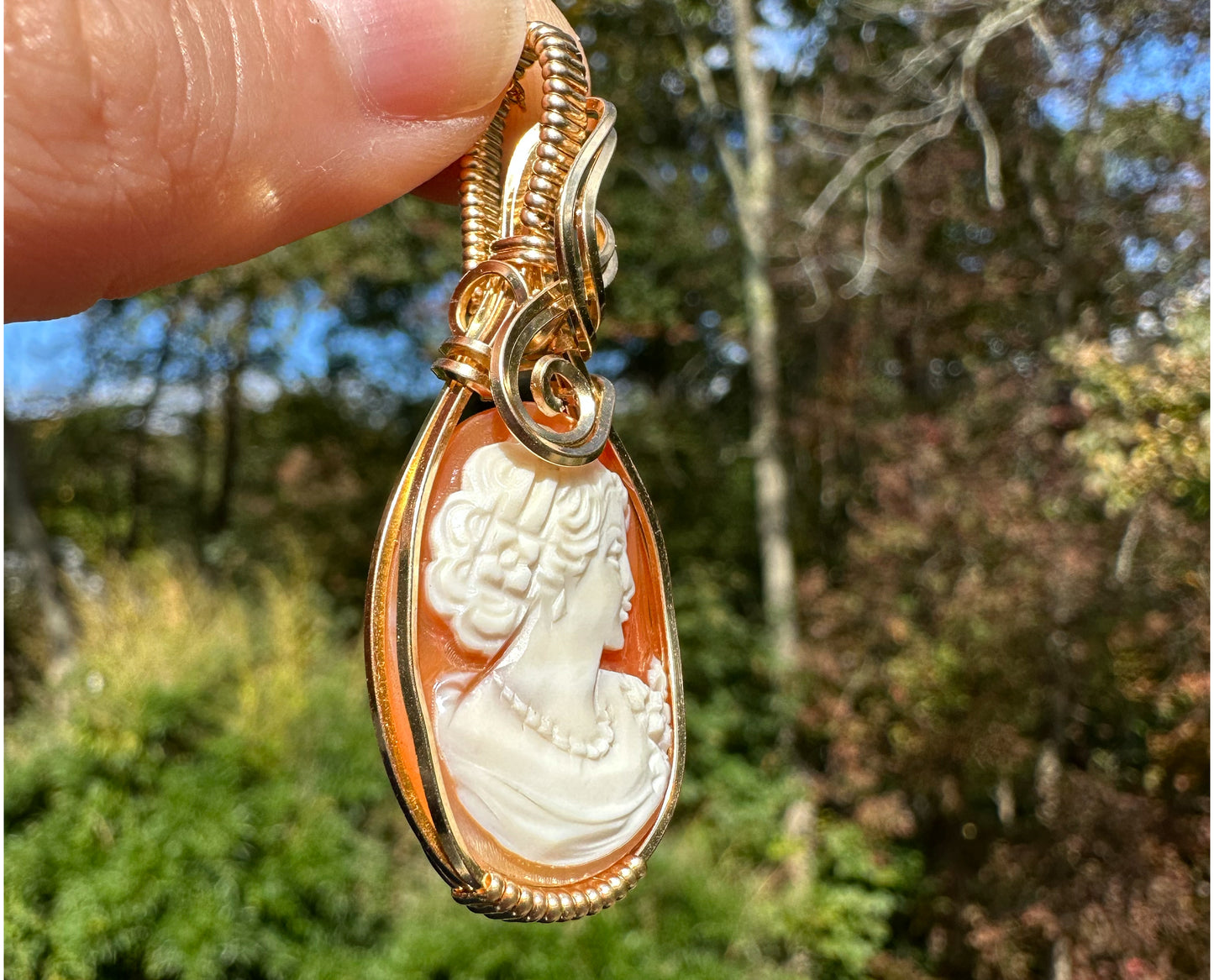 Wire wrapped 14k goldfilled wire pendant of a handcarved shell vintage cameo of a woman with a pearl necklace and flowers
