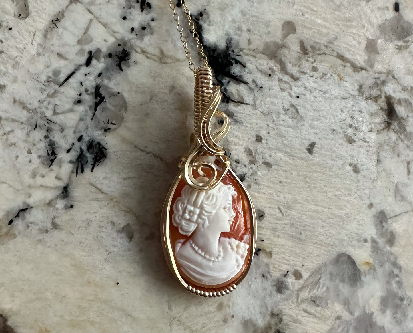 Wire wrapped 14k goldfilled wire pendant of a handcarved shell vintage cameo of a woman with a pearl necklace and flowers