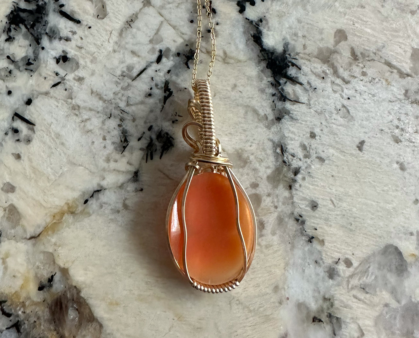 Wire wrapped 14k goldfilled wire pendant of a handcarved shell vintage cameo of a woman with a pearl necklace and flowers