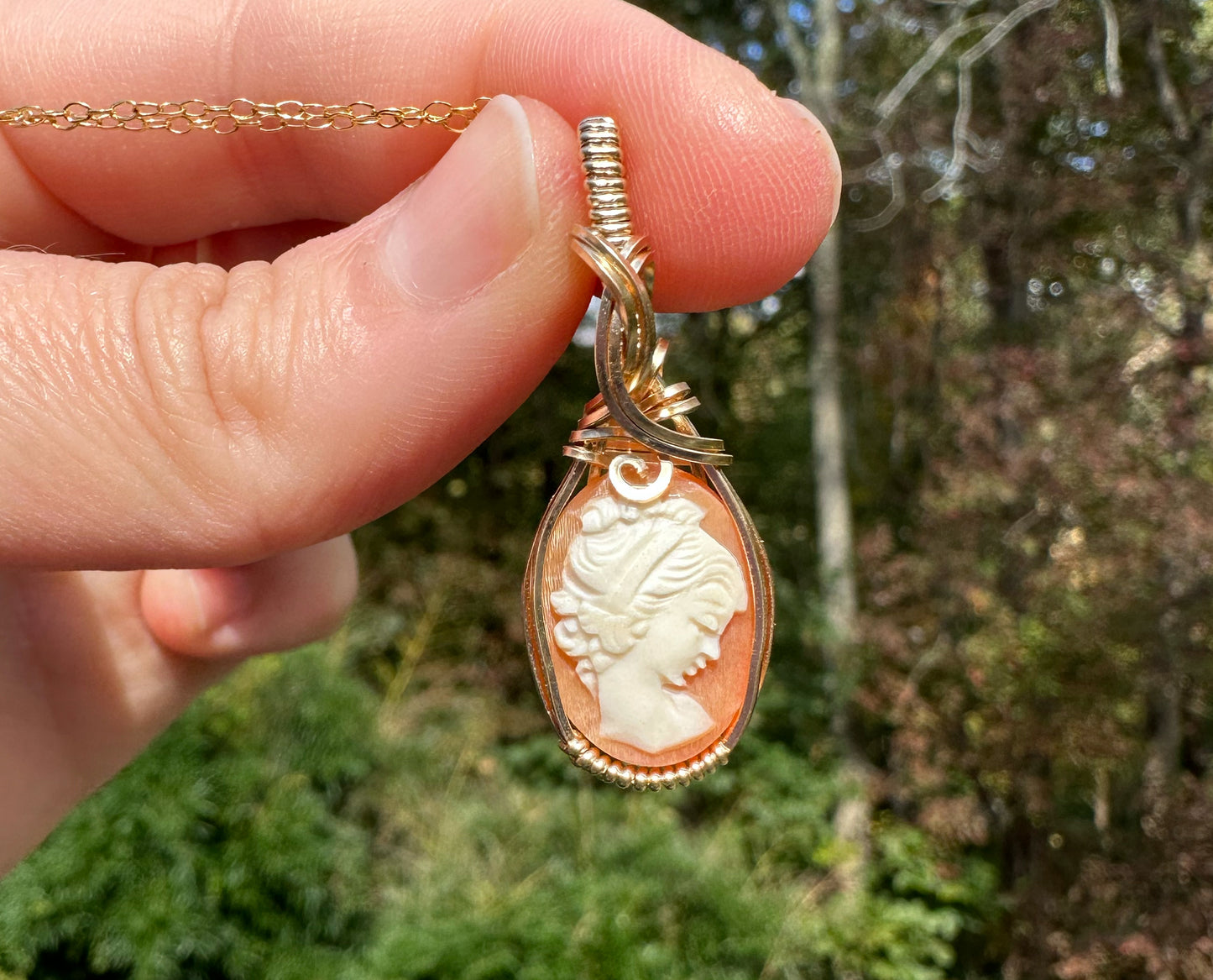 Wire wrapped 14k goldfilled wire pendant of a handcarved shell vintage cameo of a woman with a pearl necklace and flowers