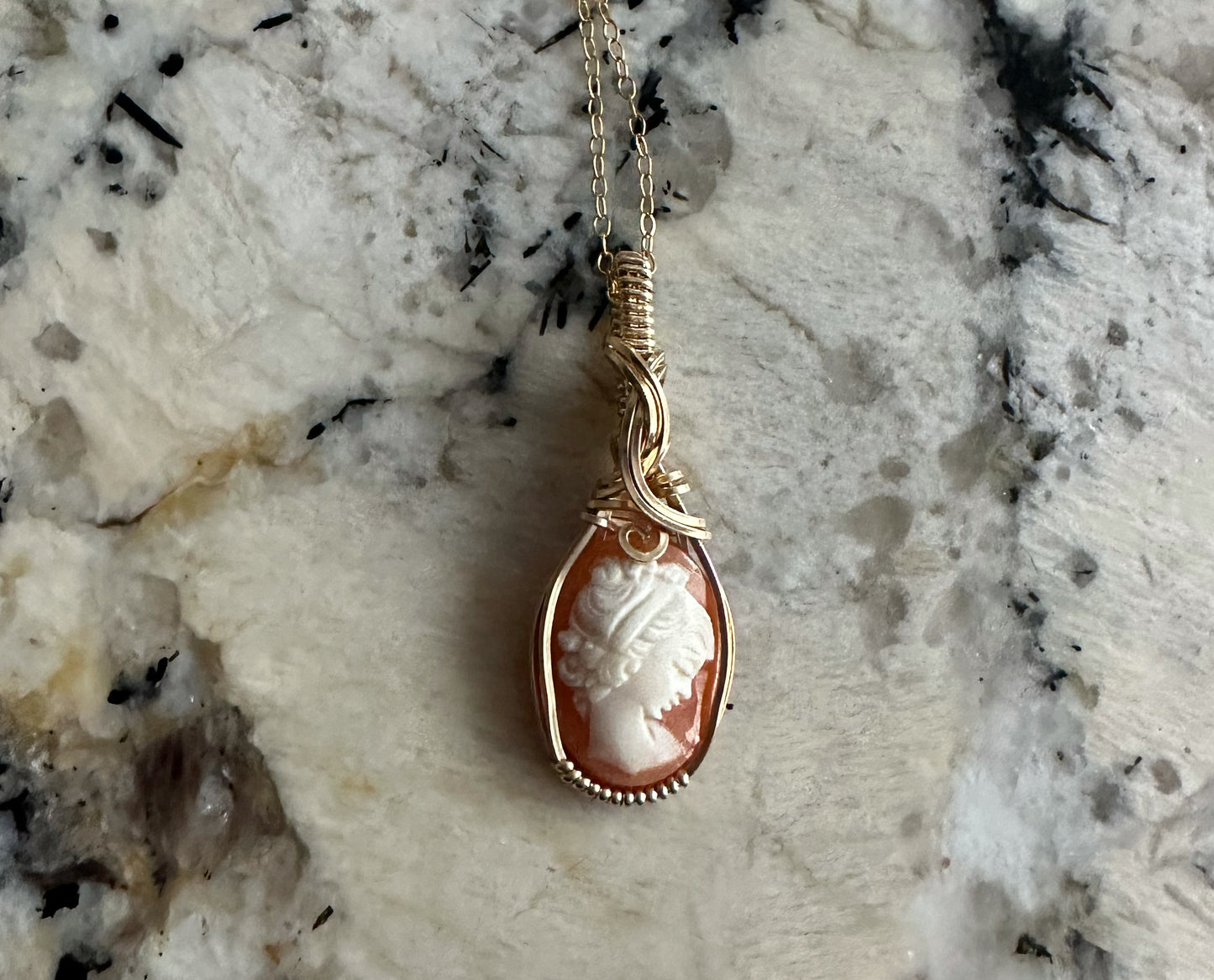 Wire wrapped 14k goldfilled wire pendant of a handcarved shell vintage cameo of a woman with a pearl necklace and flowers