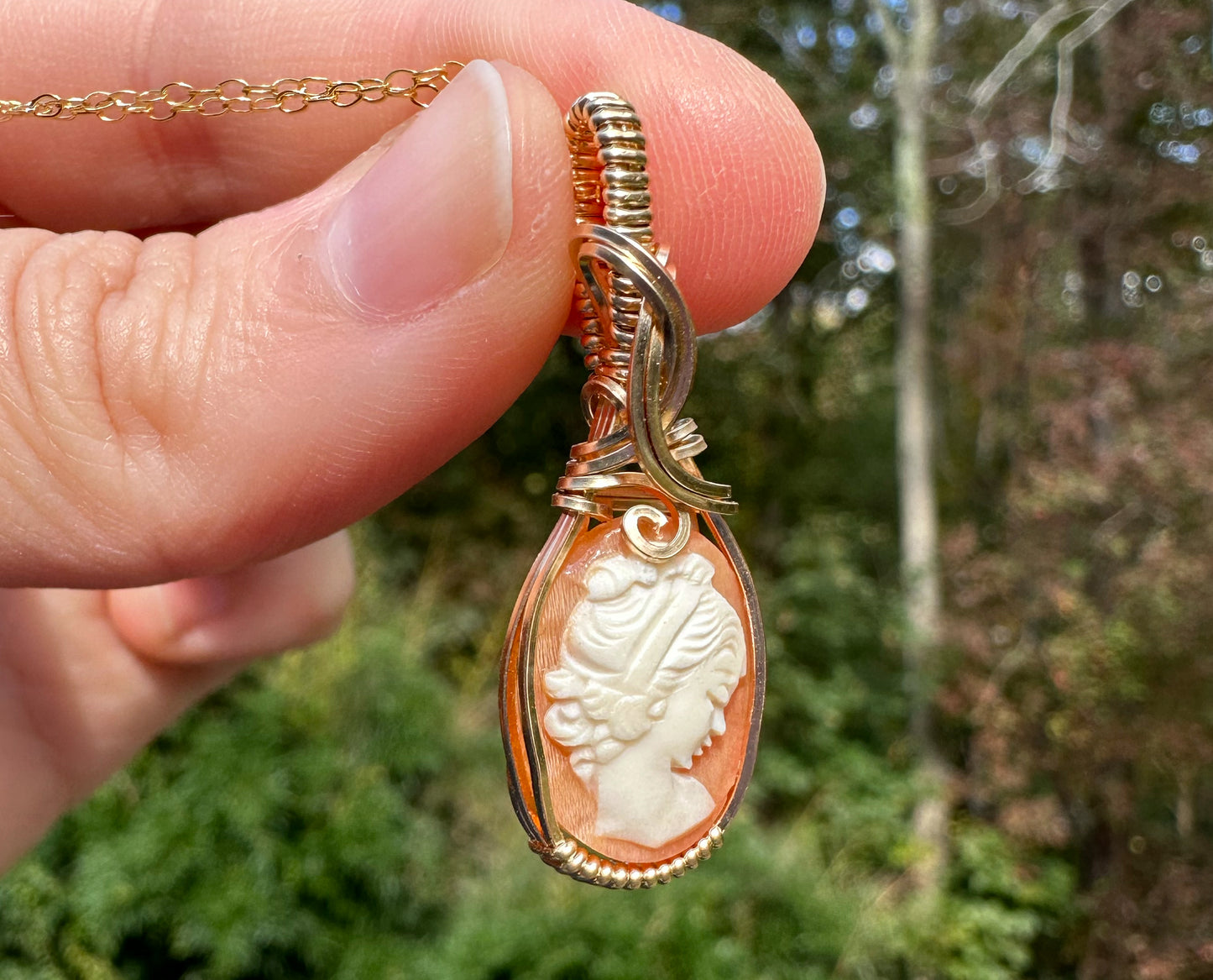 Wire wrapped 14k goldfilled wire pendant of a handcarved shell vintage cameo of a woman with a pearl necklace and flowers
