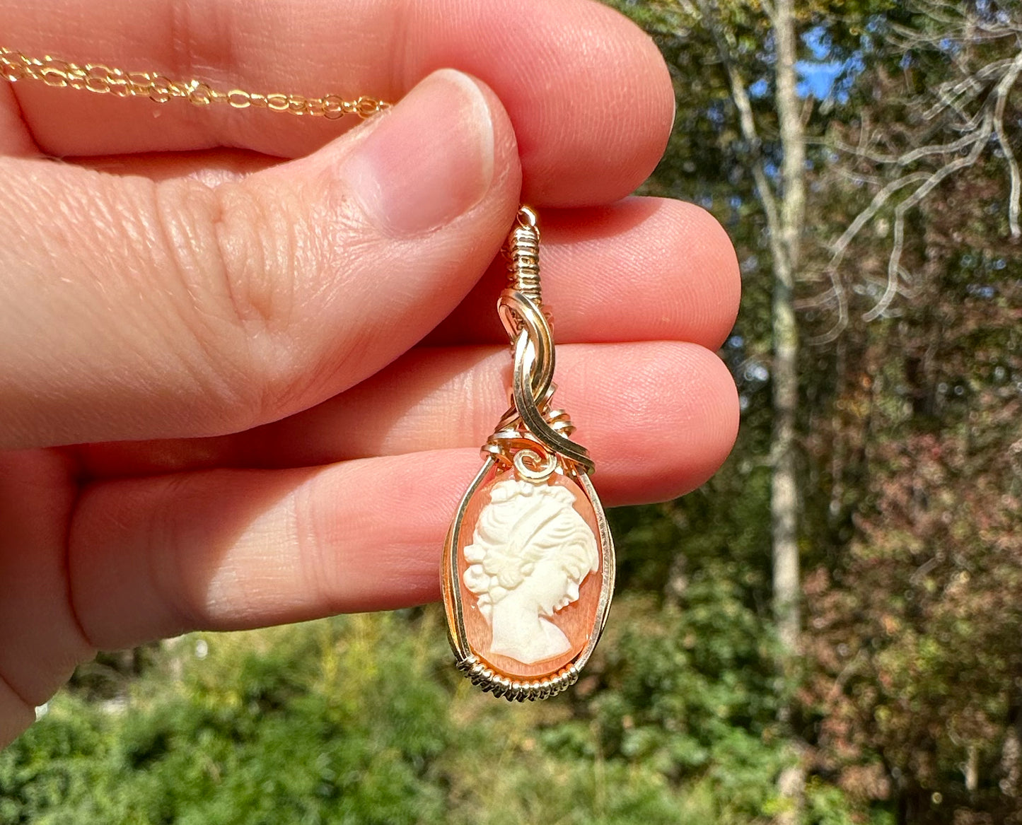 Wire wrapped 14k goldfilled wire pendant of a handcarved shell vintage cameo of a woman with a pearl necklace and flowers