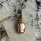 Wire wrapped 14k goldfilled wire pendant of a handcarved shell vintage cameo of a woman with a pearl necklace and flowers