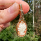 Wire wrapped 14k goldfilled wire pendant of a handcarved shell vintage cameo of a woman with a pearl necklace and flowers
