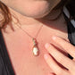 Wire wrapped 14k goldfilled wire pendant of a handcarved shell vintage cameo of a woman with a pearl necklace and flowers